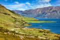 Mountain views and Lake Hawea. In summer there are green grass and blue skies with beautiful clouds Royalty Free Stock Photo