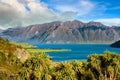 Mountain views and Lake Hawea. In summer there are green grass and blue skies with beautiful clouds Royalty Free Stock Photo