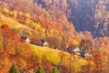 Mountain village, autumn rural scene. Yellow and orange trees. Sunny fall evening. Beautiful sunset hills landscape. Slopes, Royalty Free Stock Photo