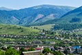 Mountain village. Small houses lost in the green Carpathian mountains. Blue sky on background Royalty Free Stock Photo