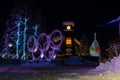 Mountain village after snowfall in night. Christmas illumination - trees, garlands and night lights, snow-covered houses, pine tre Royalty Free Stock Photo