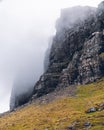 a mountain wall covered by fog