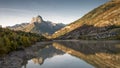 Mountain with water reflection in a lake with autumn tree forest and a small town in Aragon, Royalty Free Stock Photo