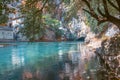 Mountain water spring with a lake under a large rock Royalty Free Stock Photo