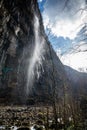 Mountain waterfall in Abkhazia. The wind blows away the pressure of the water