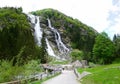 Mountain waterfall - landscape with forest road, fir trees and m Royalty Free Stock Photo