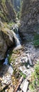 A mountain waterfall in a rocky gorge. Royalty Free Stock Photo