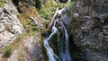 A mountain waterfall in a rocky gorge. Royalty Free Stock Photo