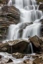 Waterfall with rocky stones, vertical image, nature background
