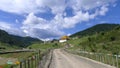 Mountain winding road with tibetan temple