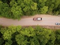 Mountain winding zig zag gravel road. Top aerial view: cars driving on road from above. Royalty Free Stock Photo