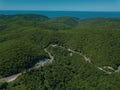 Mountain winding zig zag road. Top aerial view: cars driving on road from above. Royalty Free Stock Photo