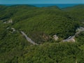 Mountain winding zig zag road. Top aerial view: cars driving on road from above. Royalty Free Stock Photo