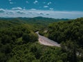 Mountain winding zig zag road. Top aerial view: cars driving on road from above. Royalty Free Stock Photo