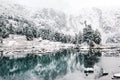 Mountain winter lake with the reflection of rocks in the water surface.