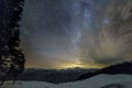 Mountain winter night panorama after sunset. Steep long ridge mountain peaks, deep snow in valley, hills covered with dense spruce Royalty Free Stock Photo