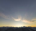 Mountain winter panorama landscape at dawn. Steep mountain peaks covered with snow and woody hills with spruce forest, raising Royalty Free Stock Photo