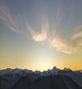 Mountain winter panorama landscape at dawn. Steep mountain peaks covered with snow and woody hills with spruce forest, raising Royalty Free Stock Photo