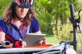 Mountainbiker with her tablet in nature Royalty Free Stock Photo