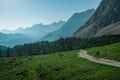 Mountainbiking in the Karwendel mountains in front of blue mountain layers, Austria Royalty Free Stock Photo