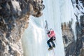 Mountaineer ascends the vertical icefall with ice picks