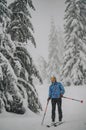 Mountaineer backcountry ski waling two ski alpinist in the mountains. Ski touring in alpine landscape with snowy trees. Adventure