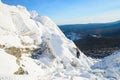 The mountaineer climbing the mountain top covered with ice and snow, man hiker going at the peak of rock. Winter season. Royalty Free Stock Photo