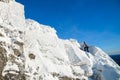 The mountaineer climbing the mountain top covered with ice and snow, man hiker going at the peak of rock. Winter season. Royalty Free Stock Photo