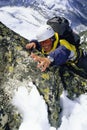 Mountaineer Climbing Snowy Rock Face