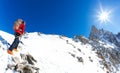 Mountaineer climbs a snowy peak. In background the famous peak Dent du Geant in the Mont Blanc Massif, the highest european mounta Royalty Free Stock Photo