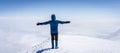 Mountaineer with crampons standing on a summit with clouds below him, Mount Ararat in Turkey Royalty Free Stock Photo