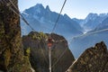 Mountaineer crossing cable bridge via ferrata, Chamonix France