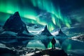 The mountaineer looks admiringly at the northern lights or Aurora phenomenon.