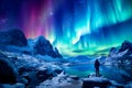 The mountaineer looks admiringly at the northern lights or Aurora phenomenon.