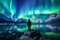 The mountaineer looks admiringly at the northern lights or Aurora phenomenon.