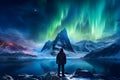 The mountaineer looks admiringly at the northern lights or Aurora phenomenon.