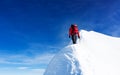 Mountaineer reach the summit of a snowy peak. Concepts: determination, courage, effort, self-realization. Royalty Free Stock Photo