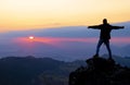 Mountaineer on a rock with the sun at sunset, Gipuzkoa from Mount Jaizkibel, Euskadi