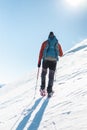 Man in snow snowshoes.