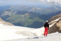 Mountaineer standing on glacier and looking towards Grossglockner High Alpine Road and mountain panorama in Glockner Group, Royalty Free Stock Photo