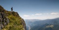 Mountaineer stands on the edge of world