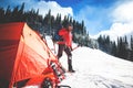 Climber near the tent with snowshoes.