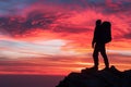 The mountaineer is on the summit contemplating the landscape.