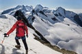 Mountaineer walks down along a snowy ridge Royalty Free Stock Photo