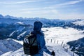 mountaineering hiker in winter looking into the distance at the summit of the snowy mountain. overlooking the clouds in the valley Royalty Free Stock Photo