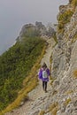 Mountaineering young woman, foggy alpine landscape