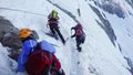 Mountaineers climb a snowy peak