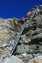 Mountaineers climbing down a steep ladder Royalty Free Stock Photo