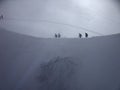 Mountaineers crossing the ridge in June, at Aiguille du Midi, Chamonix, France