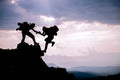 Silhouette of helping hand between two climber.Adventurous people;Hikers climbing on mountain. Help, risk, support, assistance Royalty Free Stock Photo